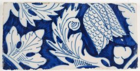Antique Delft border tile in blue with an ornament flower design, 18th century