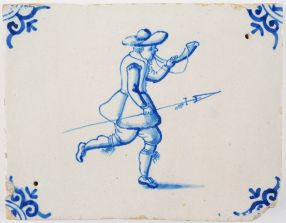 Antique Delft border tile in blue with a hunter holding a spear while blowing on a horn, 17th century
