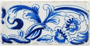 Antique Delft border tile with snakes and birds in a garland of flowers, 18th and 19th century