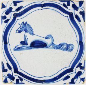 Antique Delft tile in blue with a horse lying, 17th century
