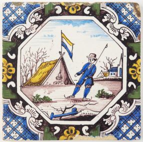Antique Delft tile with a man skating on ice in a typical Dutch winter landscape, 19th century