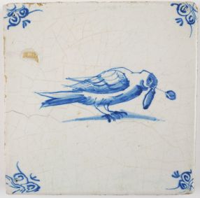 Antique Delft tile in blue with a pigeon with a twig in its beak, 17th century