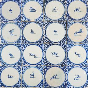 Antique Delft wall tiles in blue with small animals in a circle and Wanli inspired corner decoration, 17th century Harlingen