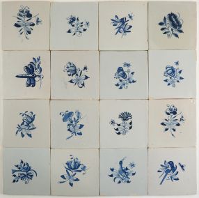 Antique Dutch Delft wall tiles with small flowers in blue