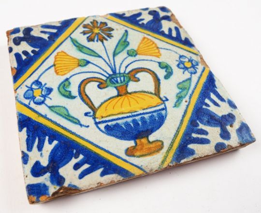 Antique Delft polychrome tile with a richly decorated flower pot